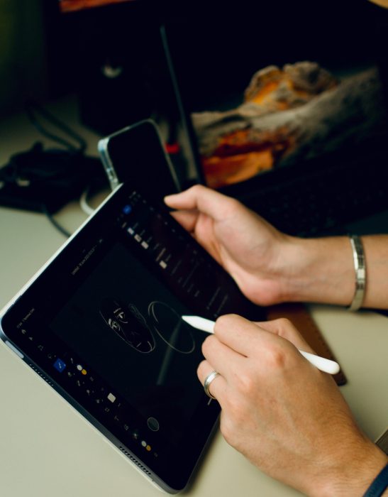 Person drawing digital art on a tablet indoors, showcasing technology and creativity.